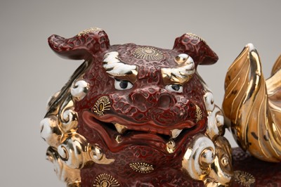 Lot 205 - AN IMARI PORCELAIN FIGURE OF A SHISHI WITH BALL