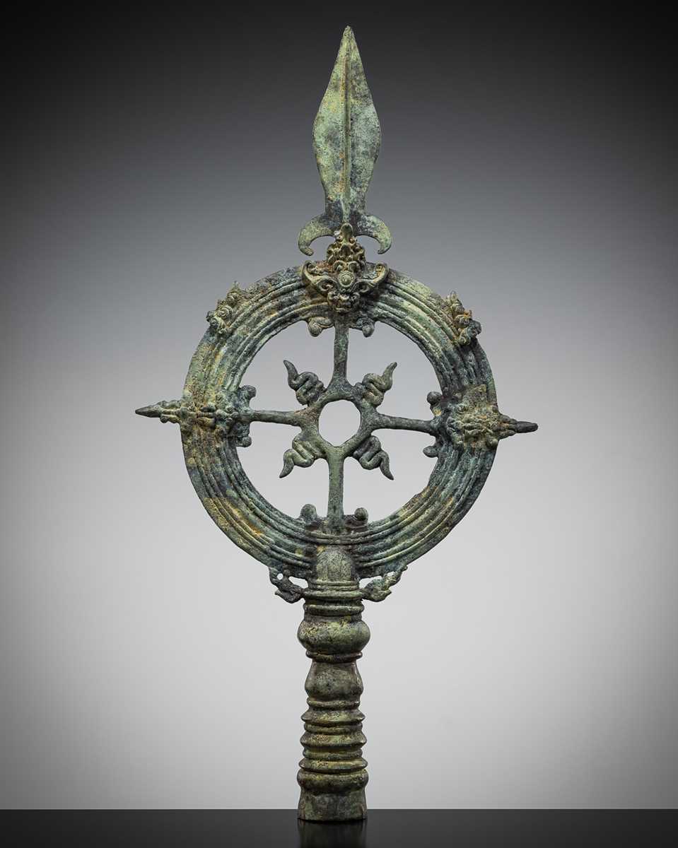 Lot 465 - A BRONZE ‘WHEEL OF LAW AND SPEAR HEAD’