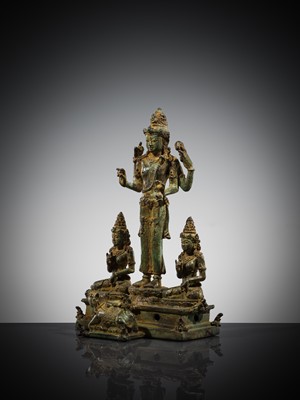 Lot 462 - A RARE BRONZE TRIAD OF SHIVA AND HIS CONSORTS PARVATI AND SATI WITH NANDI, CENTRAL JAVA, 11TH CENTURY