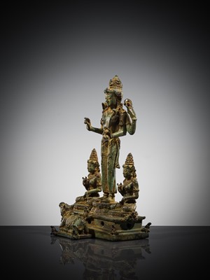 Lot 462 - A RARE BRONZE TRIAD OF SHIVA AND HIS CONSORTS PARVATI AND SATI WITH NANDI, CENTRAL JAVA, 11TH CENTURY