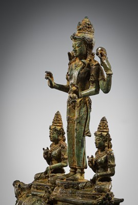 Lot 462 - A RARE BRONZE TRIAD OF SHIVA AND HIS CONSORTS PARVATI AND SATI WITH NANDI, CENTRAL JAVA, 11TH CENTURY