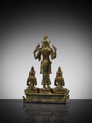 Lot 462 - A RARE BRONZE TRIAD OF SHIVA AND HIS CONSORTS PARVATI AND SATI WITH NANDI, CENTRAL JAVA, 11TH CENTURY