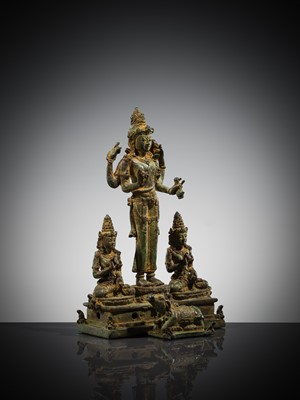 Lot 462 - A RARE BRONZE TRIAD OF SHIVA AND HIS CONSORTS PARVATI AND SATI WITH NANDI, CENTRAL JAVA, 11TH CENTURY