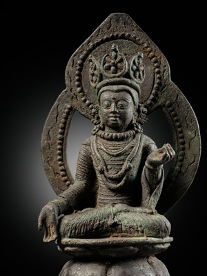 Lot 361 - A BRONZE FIGURE OF RATNASAMBHAVA ON A LION THRONE, KASHMIR, CIRCA 7TH-11TH CENTURY