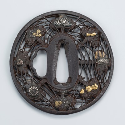 Lot 540 - AN IRON SUKASHI TSUBA WITH FLOWERS