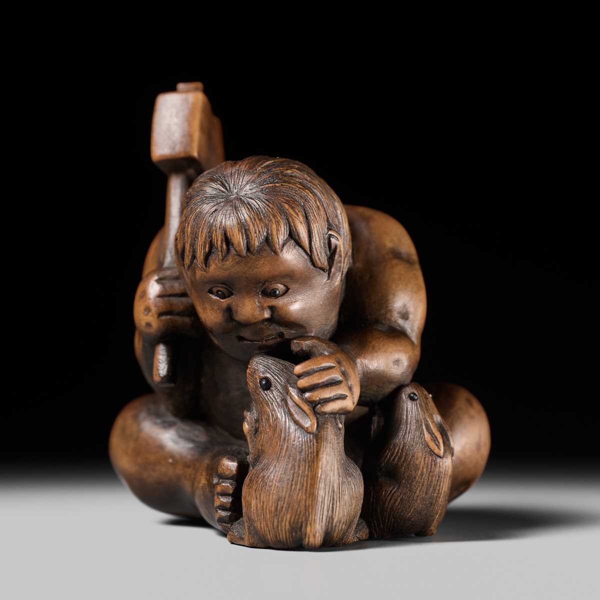 Lot 173 - A WOOD NETSUKE OF KINTARO WITH TWO RABBITS, CIRCLE OF TAMETAKA