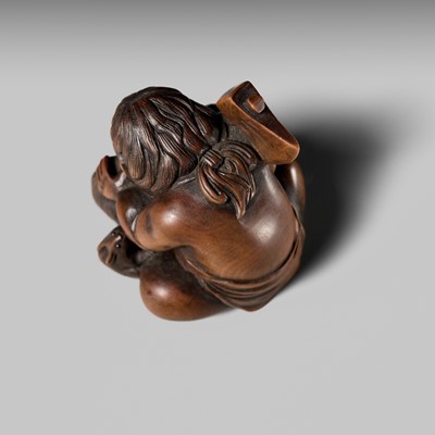 Lot 173 - A WOOD NETSUKE OF KINTARO WITH TWO RABBITS, CIRCLE OF TAMETAKA