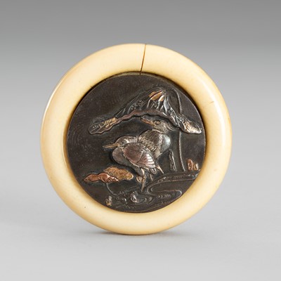 Lot 1714 - AN IVORY AND MIXED-METAL KAGAMIBUTA NETSUKE WITH LOTUS AND CRANES