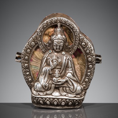 Lot 6 - A TURQUOISE-INLAID SILVER REPOUSSÉ GAU DEPICTING PADMASAMBHAVA, SIKKIM, 18TH-19TH CENTURY