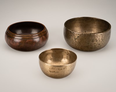 Lot 675 - A GROUP OF TWO BRASS AND ONE COPPER NEPALESE SINGING BOWLS