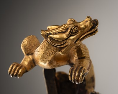 Lot 709 - A TANG-STYLE GILT BRONZE 'DRAGON' FITTING, QING DYNASTY