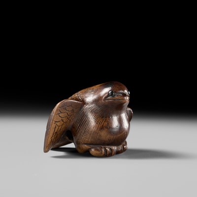 Lot 142 - YOSHINOBU: A RARE WOOD NETSUKE OF A BROODING SPARROW