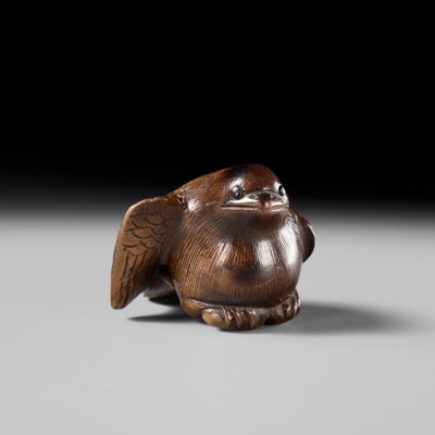 Lot 142 - YOSHINOBU: A RARE WOOD NETSUKE OF A BROODING SPARROW