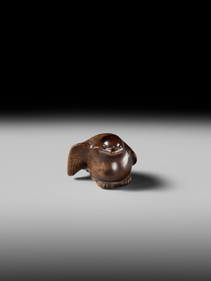 Lot 142 - YOSHINOBU: A RARE WOOD NETSUKE OF A BROODING SPARROW