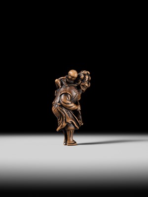 Lot 94 - A TALL WOOD NETSUKE OF A DUTCHMAN WITH CHILD