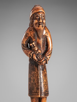 Lot 352 - HARAMASA: A WOOD NETSUKE OF A FOREIGNER