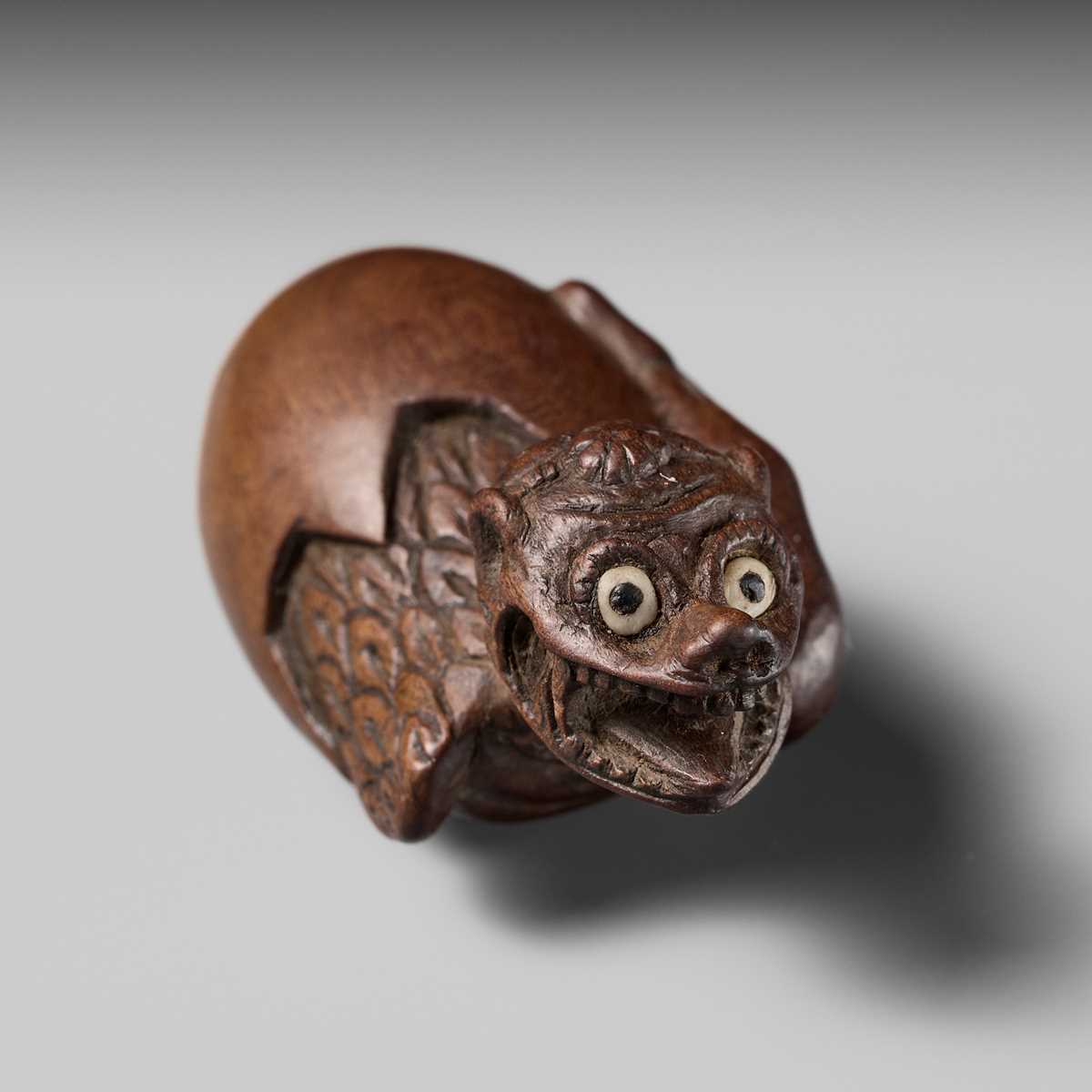 MINKO: A RARE AND UNUSUAL WOOD NETSUKE OF A HATCHING TENGU (TENGU NO TOMAGO)