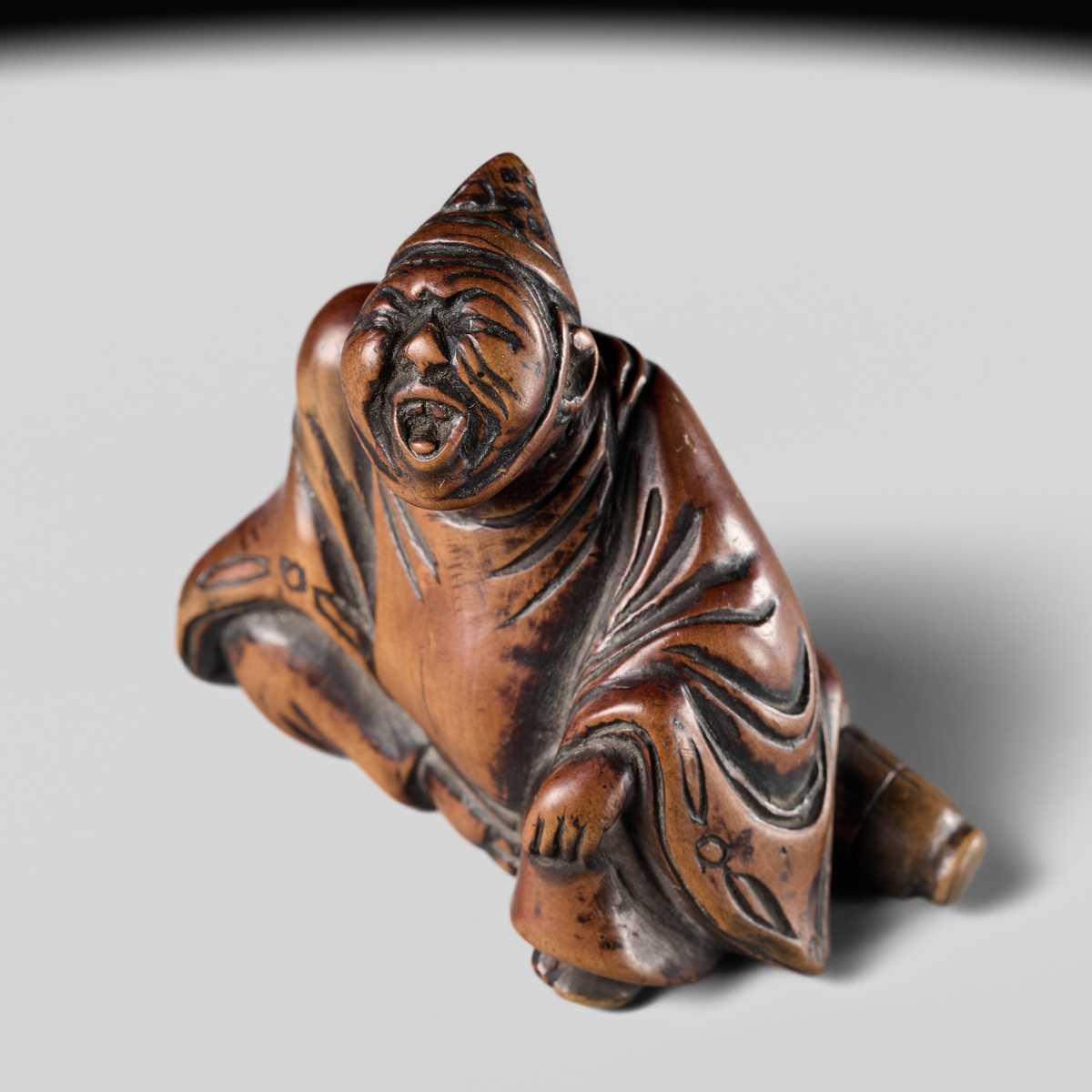 A WOOD NETSUKE OF A TEMPLE SERVANT (EJI)