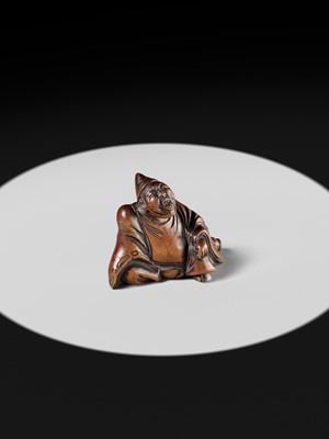 A WOOD NETSUKE OF A TEMPLE SERVANT (EJI)