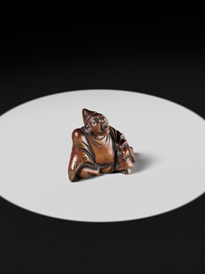 A WOOD NETSUKE OF A TEMPLE SERVANT (EJI)