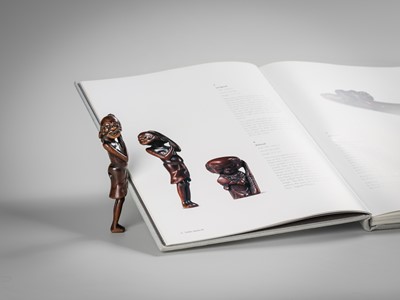 A SUPERB TALL WOOD NETSUKE OF AN EMACIATED SOUTH SEA ISLANDER
