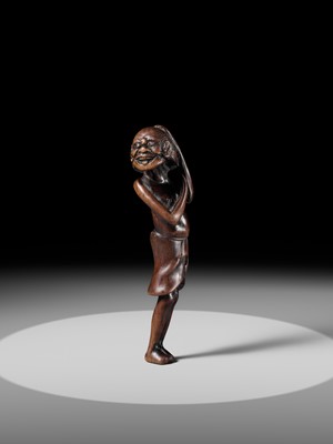 A SUPERB TALL WOOD NETSUKE OF AN EMACIATED SOUTH SEA ISLANDER