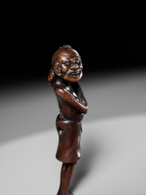 A SUPERB TALL WOOD NETSUKE OF AN EMACIATED SOUTH SEA ISLANDER