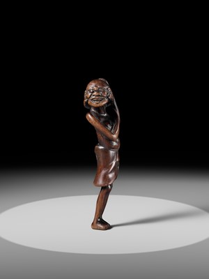 A SUPERB TALL WOOD NETSUKE OF AN EMACIATED SOUTH SEA ISLANDER