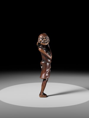 A SUPERB TALL WOOD NETSUKE OF AN EMACIATED SOUTH SEA ISLANDER