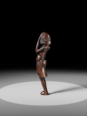 A SUPERB TALL WOOD NETSUKE OF AN EMACIATED SOUTH SEA ISLANDER