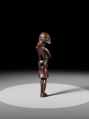 A SUPERB TALL WOOD NETSUKE OF AN EMACIATED SOUTH SEA ISLANDER