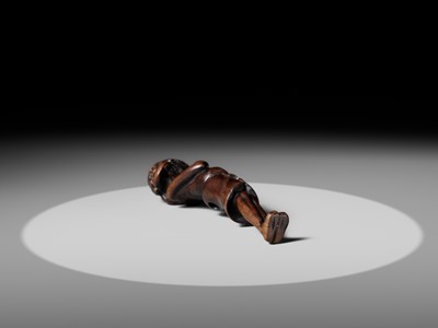 A SUPERB TALL WOOD NETSUKE OF AN EMACIATED SOUTH SEA ISLANDER