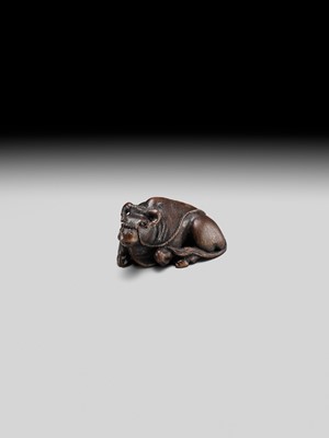 Lot 191 - ITTAN: A FINE WOOD NETSUKE OF A RECUMBENT OX