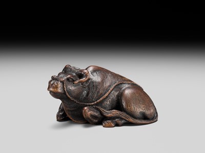 Lot 191 - ITTAN: A FINE WOOD NETSUKE OF A RECUMBENT OX
