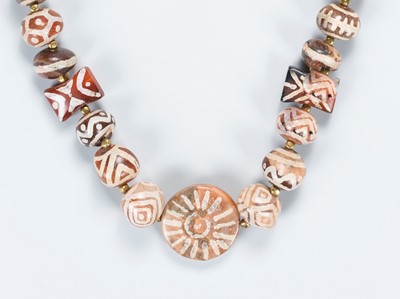 Lot 1070 - A NECKLACE WITH 41 PYU CARNELIAN AGATE BEADS, c. 7TH-9TH CENTURY