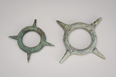 Lot 1091 - A PAIR OF STAR-SHAPED BRONZE WARRIOR’S BRACELETS, DONG SON CULTURE