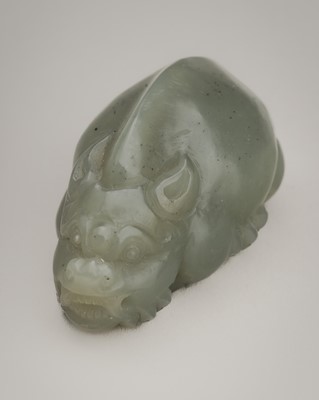 Lot 1849 - A CELADON JADE CARVING OF A MYTHICAL BEAST, C. 1900s