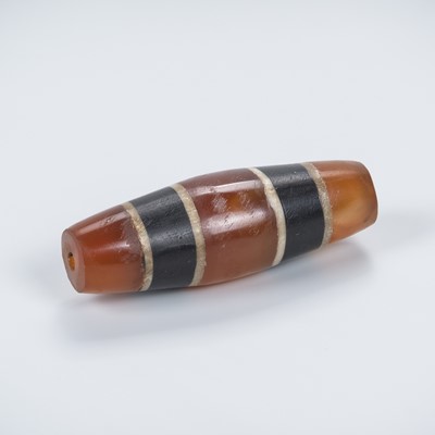 Lot 689 - A HIMALAYAN SEGMENTED ‘CHUNG DZI’ BEAD