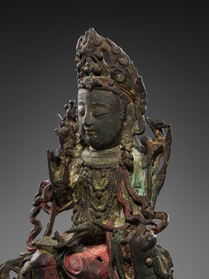 Lot 58 - A PAINTED BRONZE FIGURE OF MANJUSHRI ON A LION, MING DYNASTY