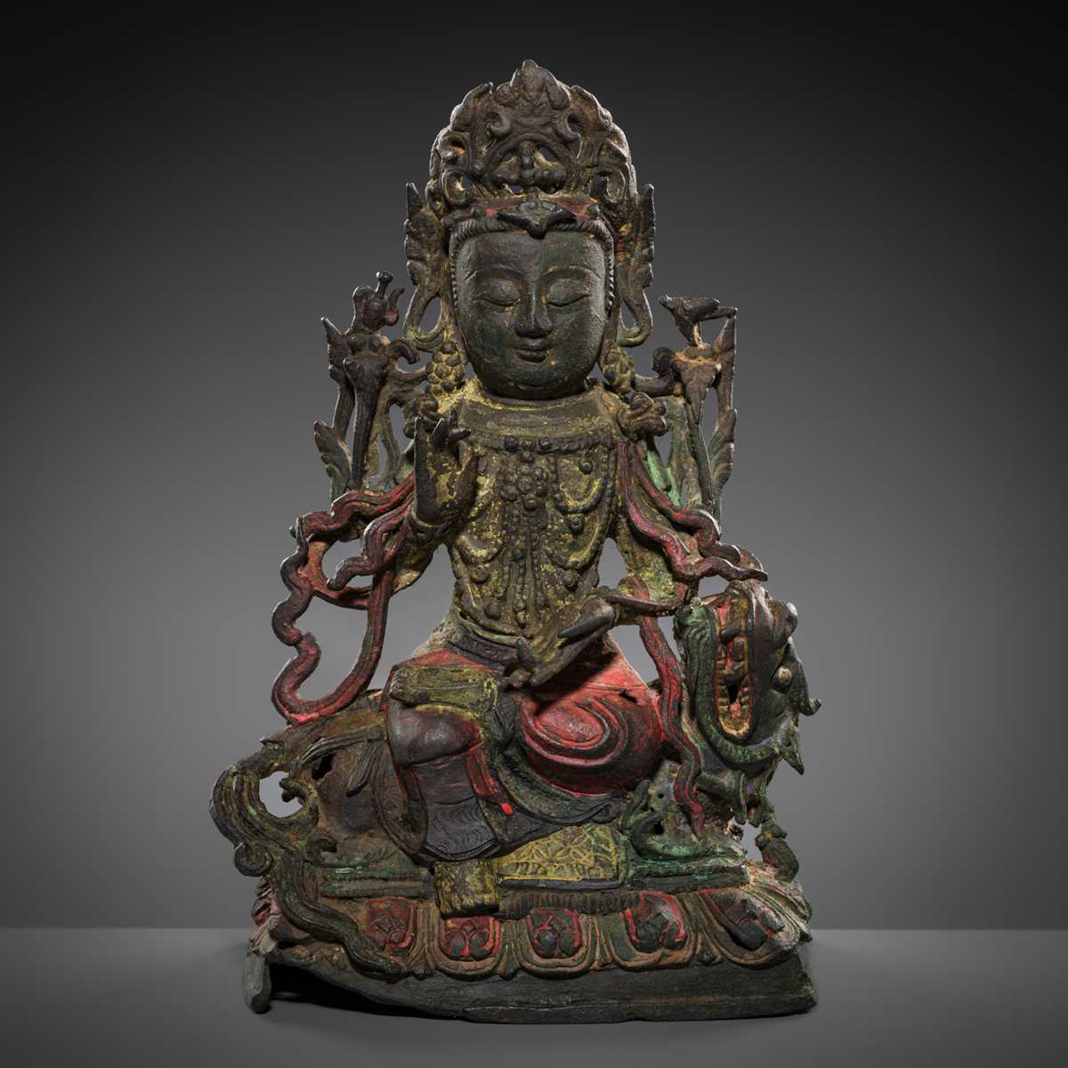 Lot 58 - A PAINTED BRONZE FIGURE OF MANJUSHRI ON A LION, MING DYNASTY