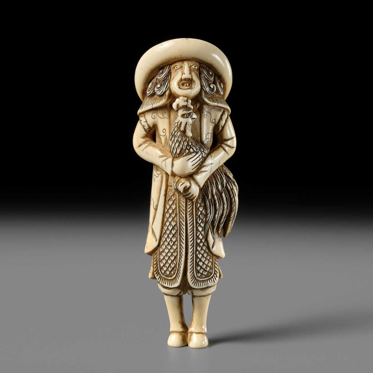 AN IVORY NETSUKE OF A DUTCHMAN WITH COCKEREL