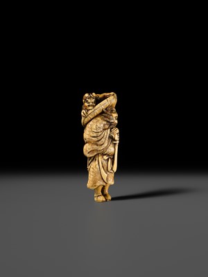 Lot 126 - A POWERFUL KYOTO SCHOOL IVORY NETSUKE OF SHOKI AND ONI