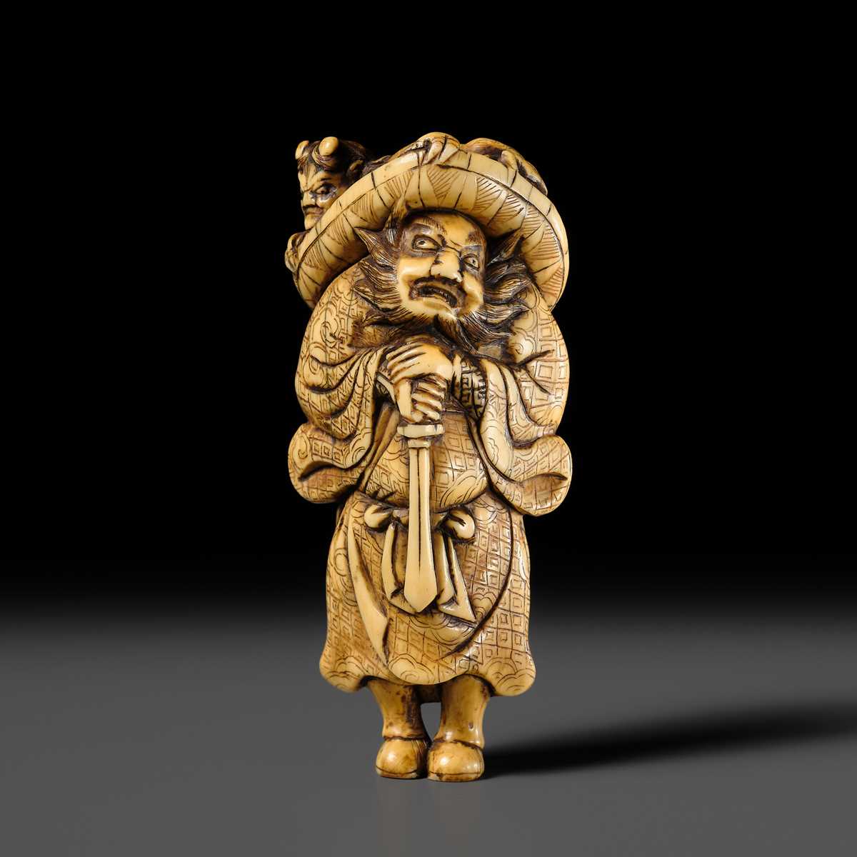 Lot 126 - A POWERFUL KYOTO SCHOOL IVORY NETSUKE OF SHOKI AND ONI