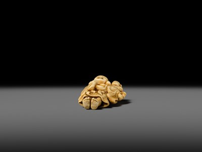 Lot 124 - OKATOMO: A FINE IVORY NETSUKE OF HOTEI WITH A KARAKO
