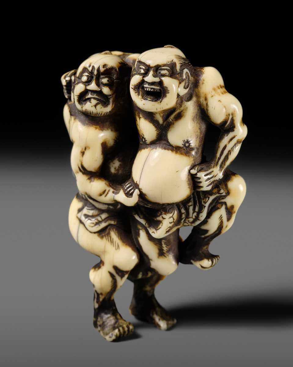 Lot 130 - AN IVORY NETSUKE OF THE TWO SUMO WRESTLERS KAGEHISA AND SUKEYASU