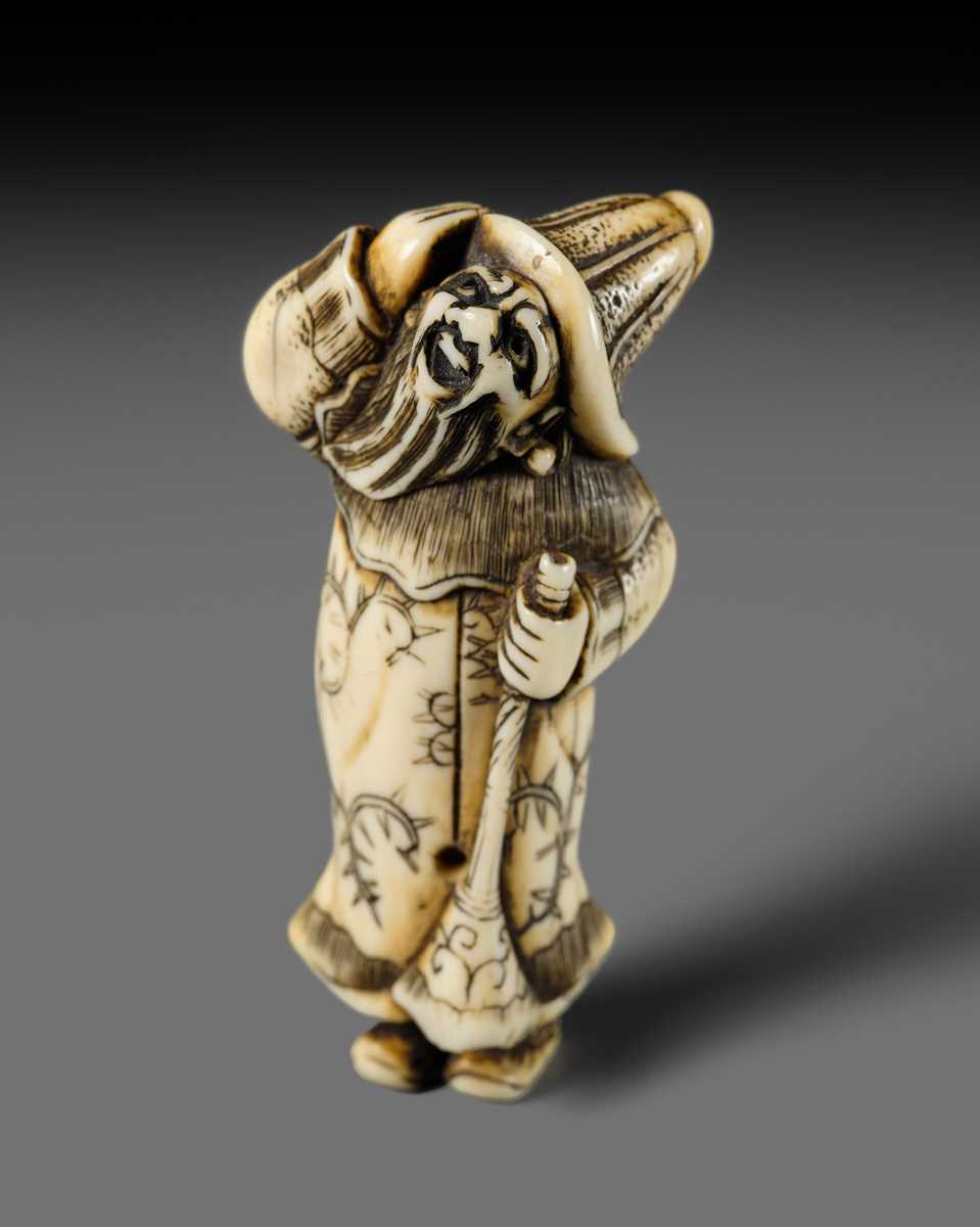 Lot 131 - NIRAKU: AN OSAKA SCHOOL IVORY NETSUKE OF A DUTCHMAN WITH A TRUMPET