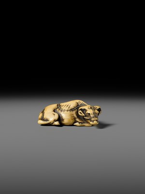 A GOOD KYOTO SCHOOL IVORY NETSUKE OF A RECUMBENT OX