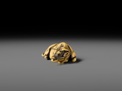A GOOD KYOTO SCHOOL IVORY NETSUKE OF A RECUMBENT OX