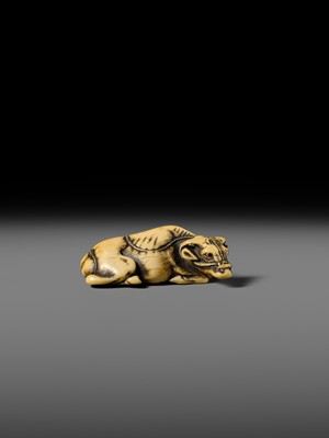 A GOOD KYOTO SCHOOL IVORY NETSUKE OF A RECUMBENT OX