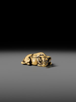 A GOOD KYOTO SCHOOL IVORY NETSUKE OF A RECUMBENT OX